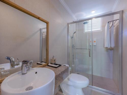 a bathroom with a toilet and a sink and a shower at Kaani Beach Hotel - Stay 3 Nights and Save 20 Percent on Spa and 10 Percent on Dining Until 31 October 2026 in Maafushi