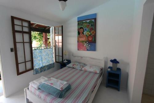 Säng eller sängar i ett rum på Vila Luiza Ubatuba