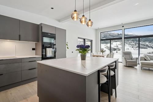 a kitchen with a large island and a living room at Olden house fjord and sunset in Stryn