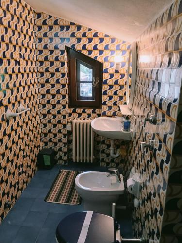 a bathroom with a sink and a toilet at Appartamento La Primula in Madesimo