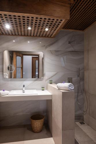 a bathroom with a sink and a mirror at Royal Horizon Baobab in Somone