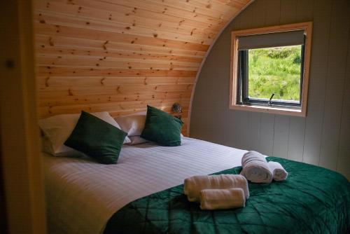 a bedroom with a large bed with a window at Calmwater Hideaway in New Hey