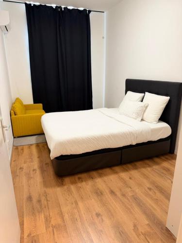a bed in a room with a black curtain at Ejon in Lelystad