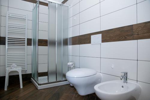 a white bathroom with a toilet and a sink at Agriturismo Sant'Anna in Sanremo