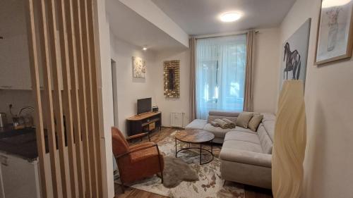 a living room with a couch and a table at Kolonáda in Poděbrady