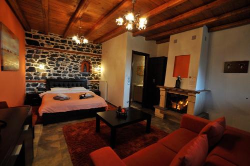 a bedroom with a bed and a fireplace at Enastron in Palaios Agios Athanasios