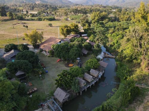 an aerial view of a house on a river at Lion Cafe Resort in Ban Huai Sieo