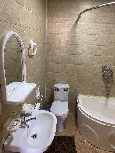 a bathroom with a sink and a toilet and a tub at TURKMAN's PALACE in Urganch