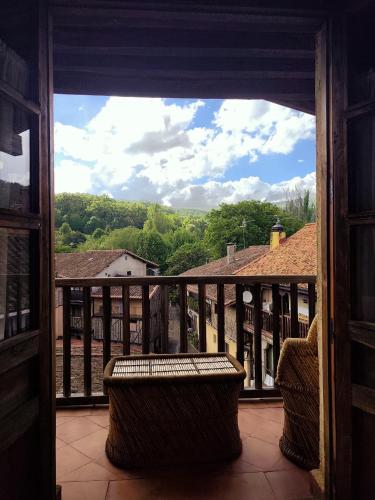 a balcony with two benches and a view of trees at La Posada de San Martin in San Martín del Castañar