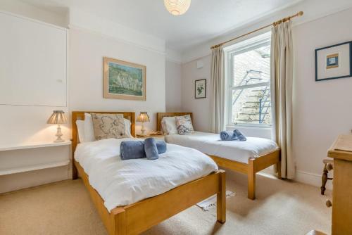 a bedroom with two beds and a window at 3 Bed in Polruan oc-pc049 in Fowey