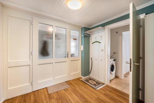 a laundry room with a washer and dryer at Park – House in Oldenburg in Holstein