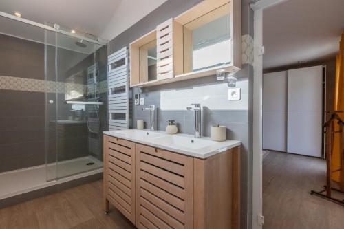 a bathroom with a sink and a shower at Villa NOVA in Capbreton