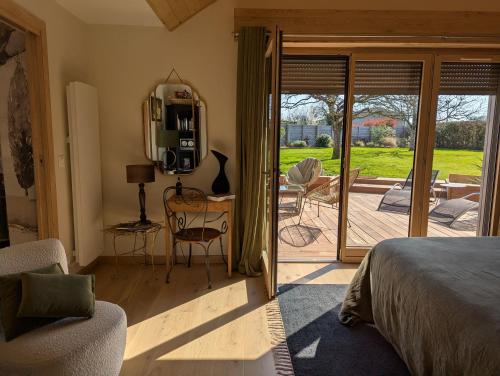 a bedroom with a bed and a door to a patio at Apart'é in Saint-Brisson-sur-Loire