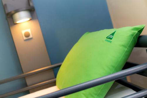 a green pillow sitting on top of a bunk bed at YHA Penzance in Penzance