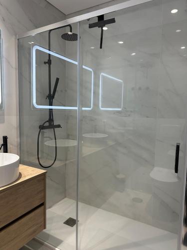 a bathroom with a glass shower with two sinks at Premium T1 - Blue Ocean in Espinho
