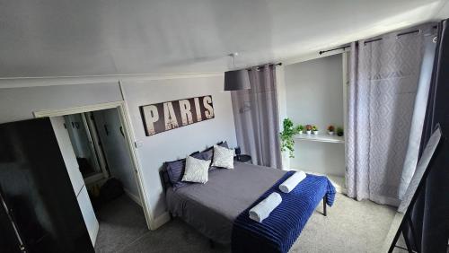 a bedroom with a bed with a sign on the wall at Entire 3 bed house in Gloucester in Gloucester