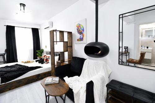a bedroom with a bed and a table at Occo by the Pool in Popeşti-Leordeni