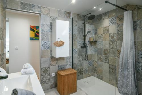 a bathroom with a tub and a shower at Maison du Bonheur, Gîtes in Le Pin