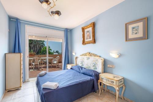 a blue bedroom with a bed and a table at Villa Santa Susanna 18 in Santa Susanna