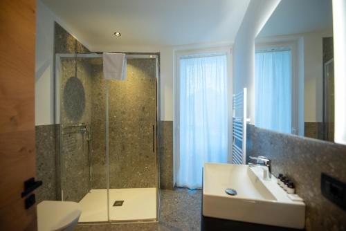 a bathroom with a shower and a sink at mySHH Smart in Vigo di Fassa