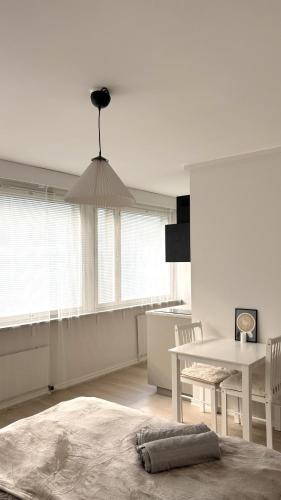 a white room with a table and a dining room at City Studio Kalliossa in Helsinki
