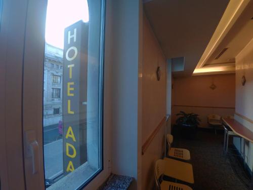 a room with a window with a sign that reads hotelosa at Hotel Ada in Milan