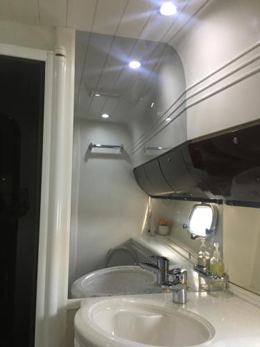 a bathroom with a sink and a mirror at Only One Yacht Cape Town in Cape Town