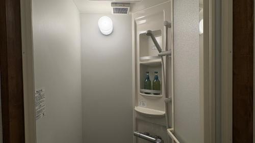 a bathroom with a door with bottles of wine at New open - ねどことあさげナマケモノ Nedoko & Asage by Sloth - Japanese Traditional House in Ōno