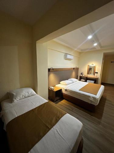 a hotel room with two beds in a room at Fırat Otel in Marmaris