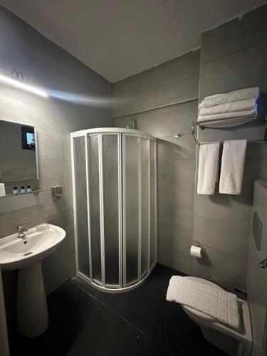 a bathroom with a shower and a sink at Fırat Otel in Marmaris