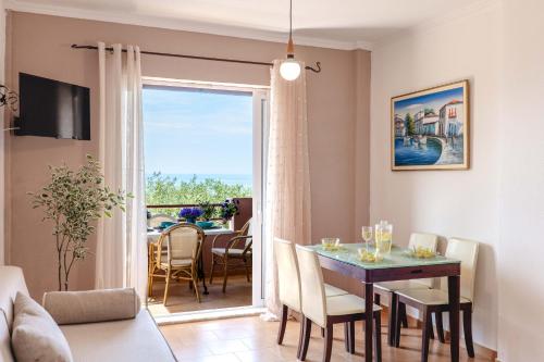 a living room with a dining room table with a view at Corfu Glyfada Beach Apartment 58a in Corfu