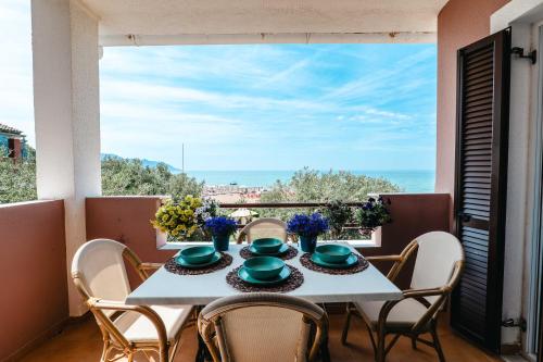 a table on a balcony with a view of the ocean at Corfu Glyfada Beach Apartment 58a in Corfu