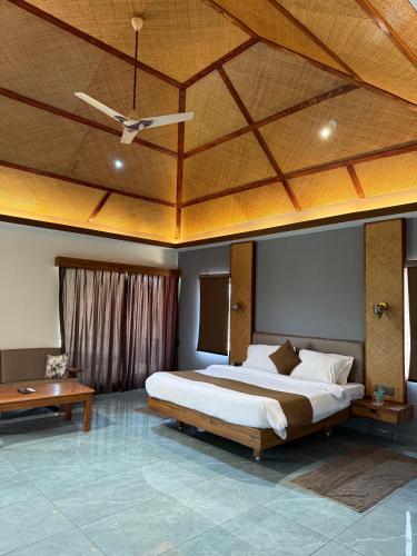 a bedroom with a large bed and a ceiling at Jawai's Wildness Lodge in Bera