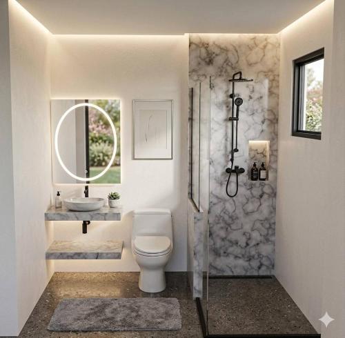 a bathroom with a toilet and a sink and a shower at D.R. Lanta Bay Resort in Ko Lanta