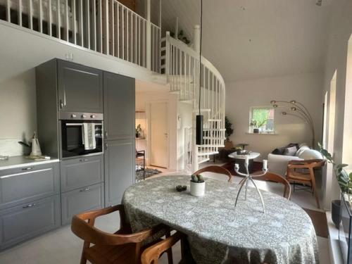 a kitchen and dining room with a table and chairs at Gunnegårds gästhus in Fleninge