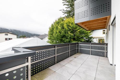 a balcony with a black and white fence at Schwarzhans Appartments in Bludenz