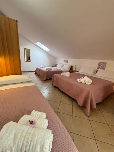 a hotel room with two beds with towels on them at Hotel Dream in Rimini