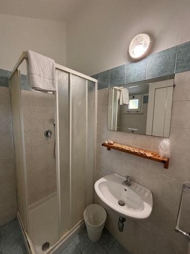 a bathroom with a shower and a sink and a mirror at Hotel Dream in Rimini