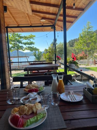 a table with plates of food on a table with a view at Bujtina Sarda in Rragam
