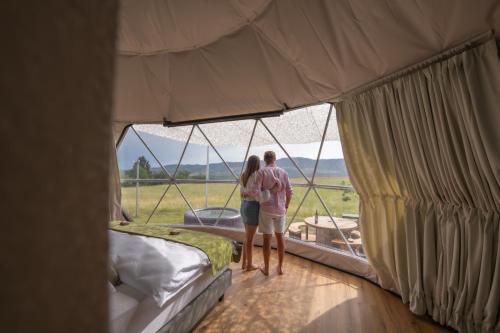 two people standing in a tent looking out the window at Glamping-Steiermark in Pöllauberg