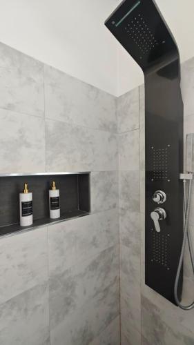 a bathroom with a shower with two candles in it at Mediterraneum in Sannicola