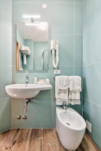 a bathroom with a sink and a mirror at Hotel Meublè Zenith in Lignano Sabbiadoro