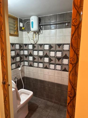 a bathroom with a toilet and a sink at wonderful stays in Tirupati