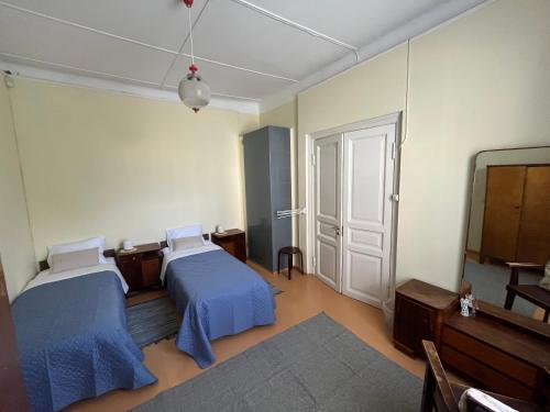 a room with two beds and a tv in it at Vekšin Old Town & Promenade Apartment, Haapsalu in Haapsalu