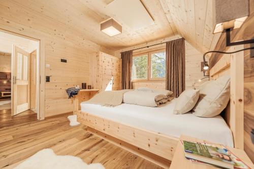 a bedroom with a bed in a log cabin at Almhof Roswitha in Hippach