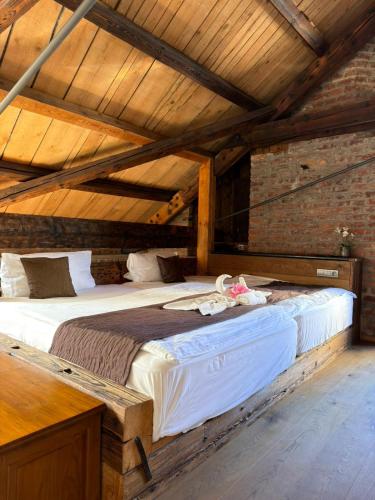 a bedroom with a large bed in an attic at Pension U Hastrmana in Prague