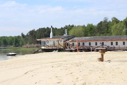 a building with graffiti on it next to a beach at Secret River Rooms in Pereiaslav-Khmelnytskyi