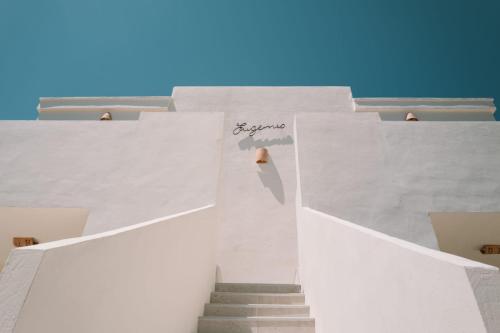 a stairway leading up to a white building at Apartamentos Eugenio by Formentera Passport in La Savina