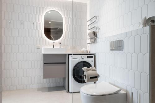 a bathroom with a washing machine and a sink at Marienholm Seaview Apartment in Haapsalu