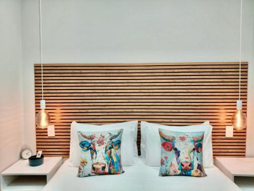 a bed with two pillows with cows on it at The Stetson - Paarl - Self Catering Apartment in Paarl